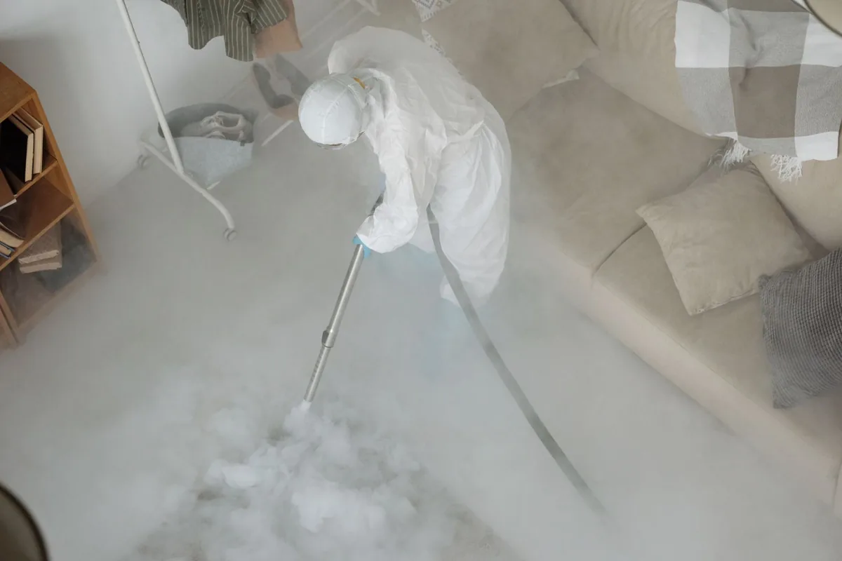 Biohazard cleanup technician in protective equipment, Rendon, TX